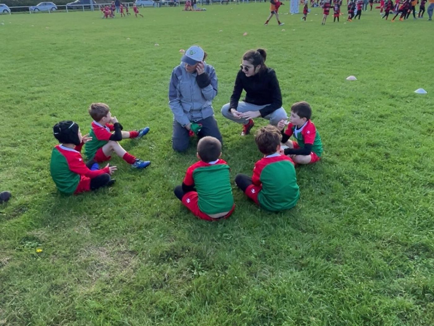 Groupe U8 assis en cercle avec les éducateurs, débriefing